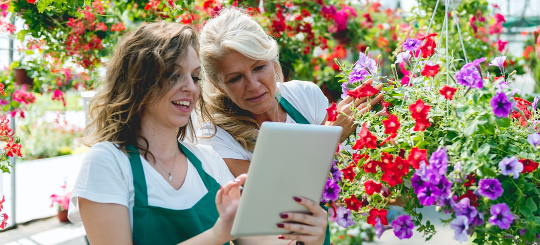Dos mujeres floristas consultando desde la tablet algunos detalles